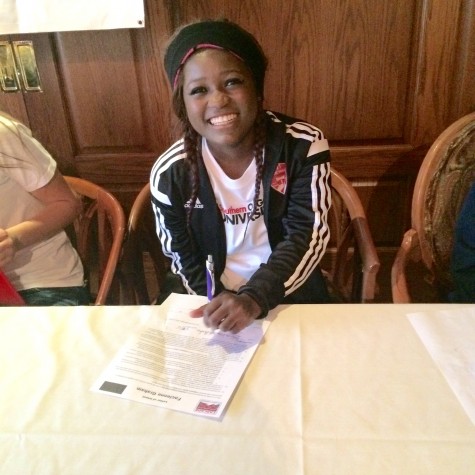 Facie Graham signing her letter of intent.