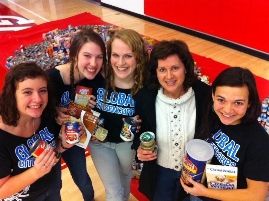 GCC Co-presidents (From left to right) Emma Cobb, Erin Keoppen, Isis Terrall, and Ellia Shelton pose for a snapshot with 1700 cans.